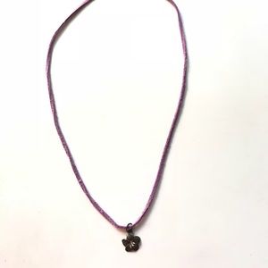 Small metal flower necklace on purple suede chain!
